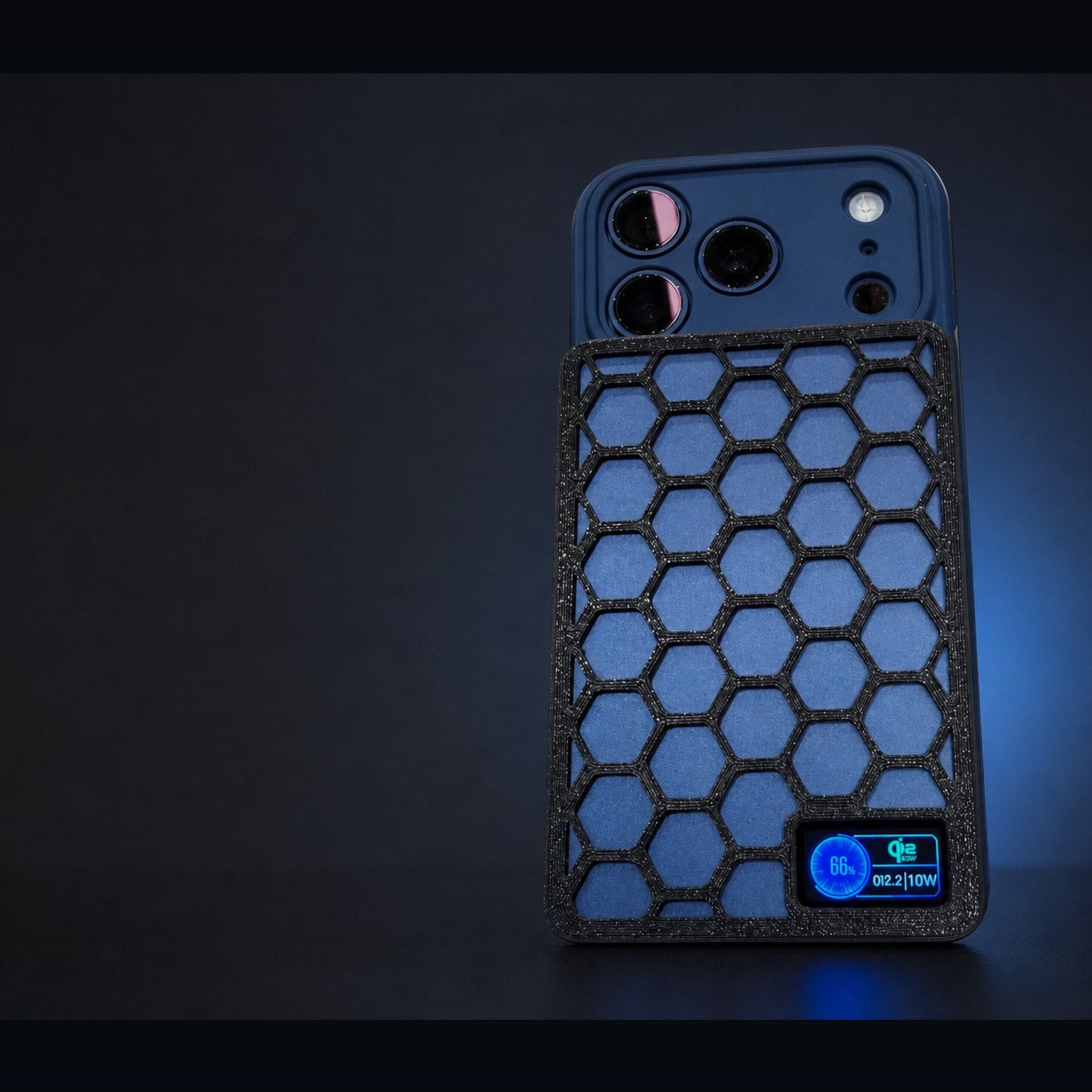 A dark blue protective phone case with a black honeycomb-patterned front panel and a built-in blue power bank connector, shown on a dark background with blue lighting. Text at the top reads 'VELOLAYERS M17 VORON GUARD'.